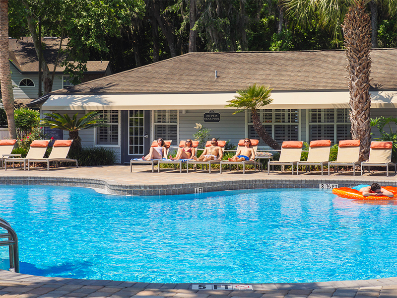 View of the pool with lounge chairs on the other side